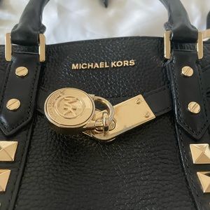 USED MICHAEL KORS HANDBAG WITH LOCK AND KEY, STORAGE BAG INCLUDED.